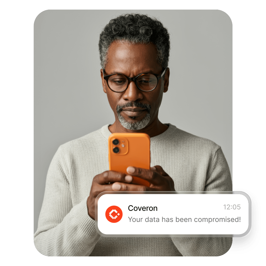  A man using a smartphone to read Coveron’s alert about his data being compromised.