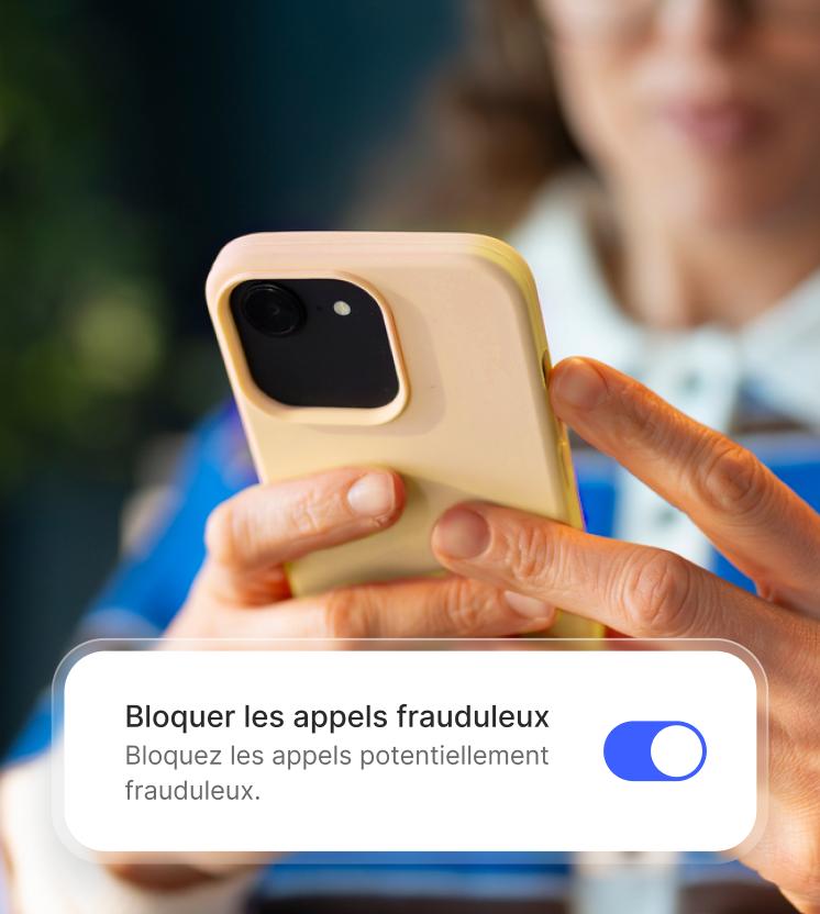 A woman enables the spam call blocker on her phone.