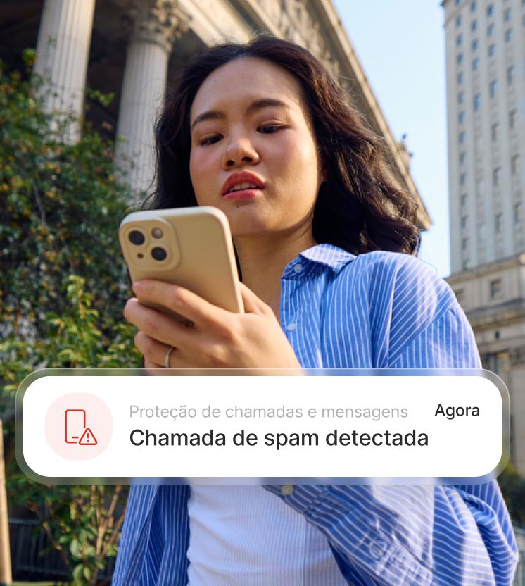 A woman receives a warning that an incoming call may be a scam.