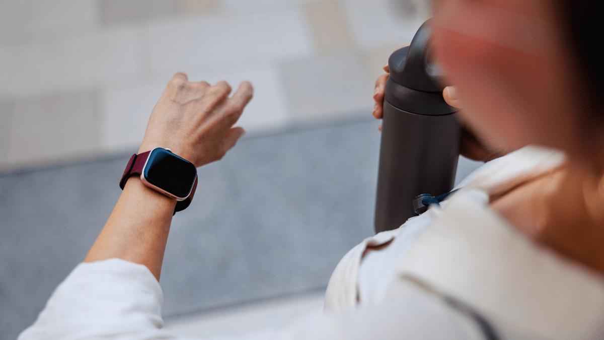 Person checking a smartwatch after exercise.