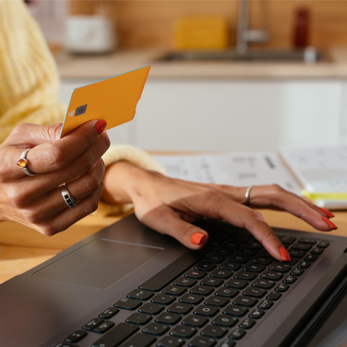 A person typing their credit card information into a website.