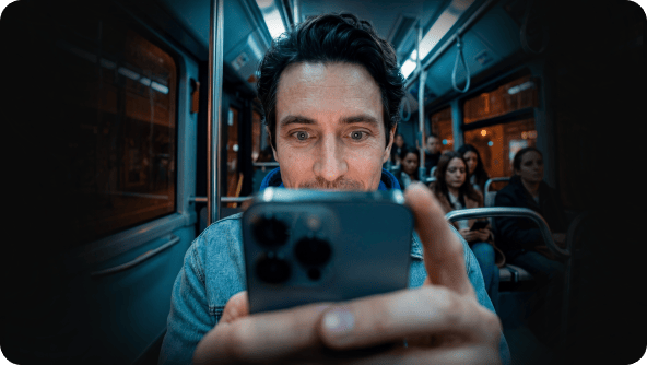 A person staring into their smartphone screen while on the bus.