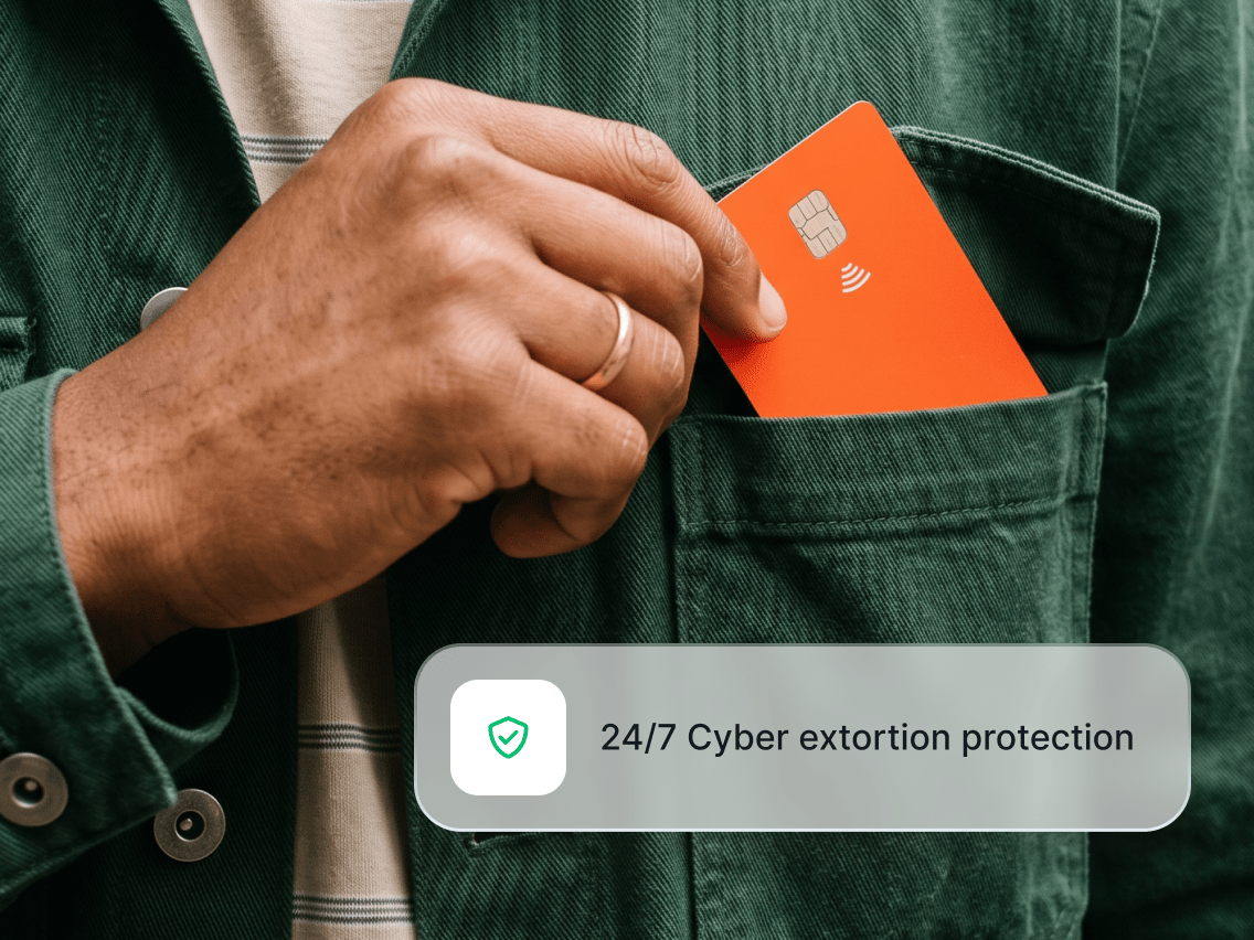 A person putting a credit card in their jacket’s breast pocket.