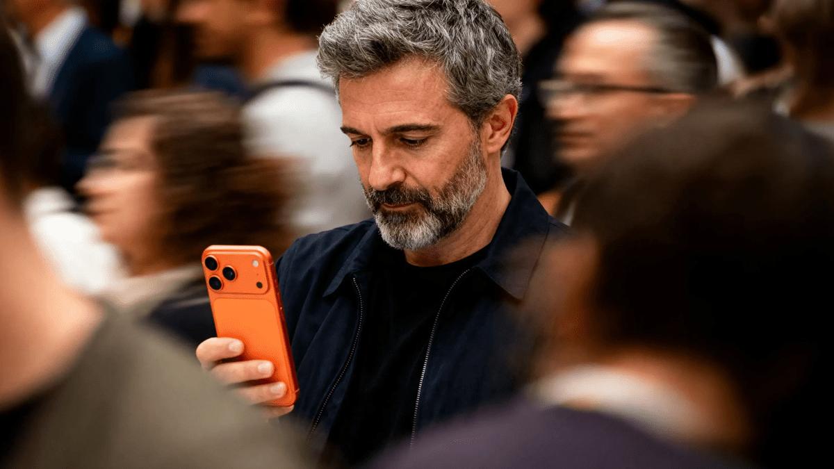 Man using his phone in a crowd, illustrating Coveron identity theft protection.