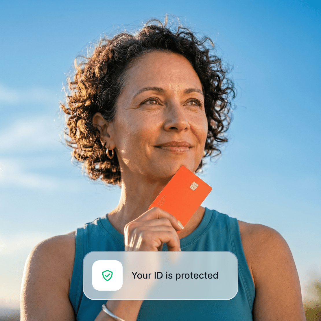 A person holding a credit card in their hand while protected by Coveron’s identity theft protection.