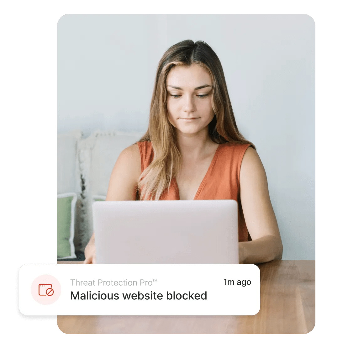 A person reading an alert from Threat Protection Pro™ about a blocked malicious website.