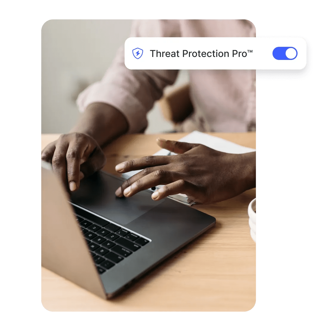 A man browsing securely on his laptop with the Threat Protection Pro feature enabled.