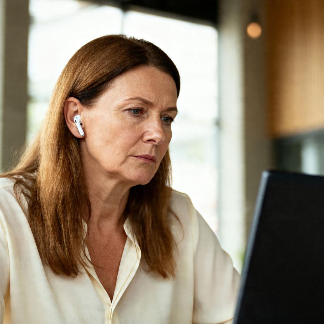 A person using their laptop to check what kind of scams Coveron&#39;s Scam Protection feature covers.