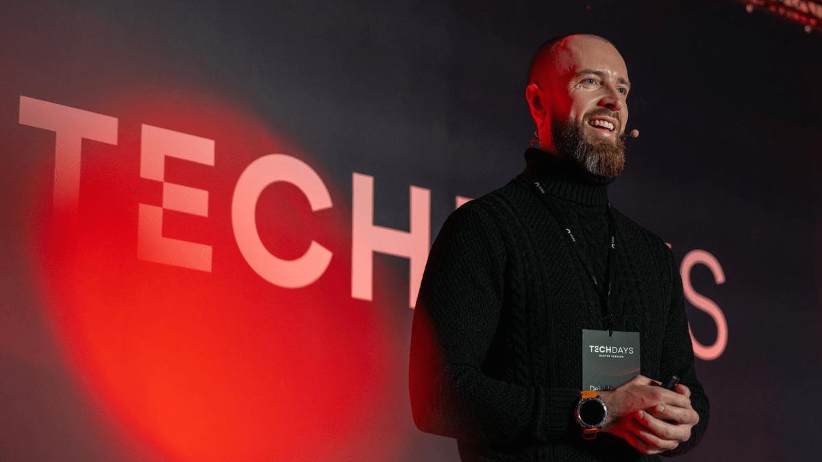 Speaker on stage in front of a Tech Days backdrop at Nord Security Tech Days.