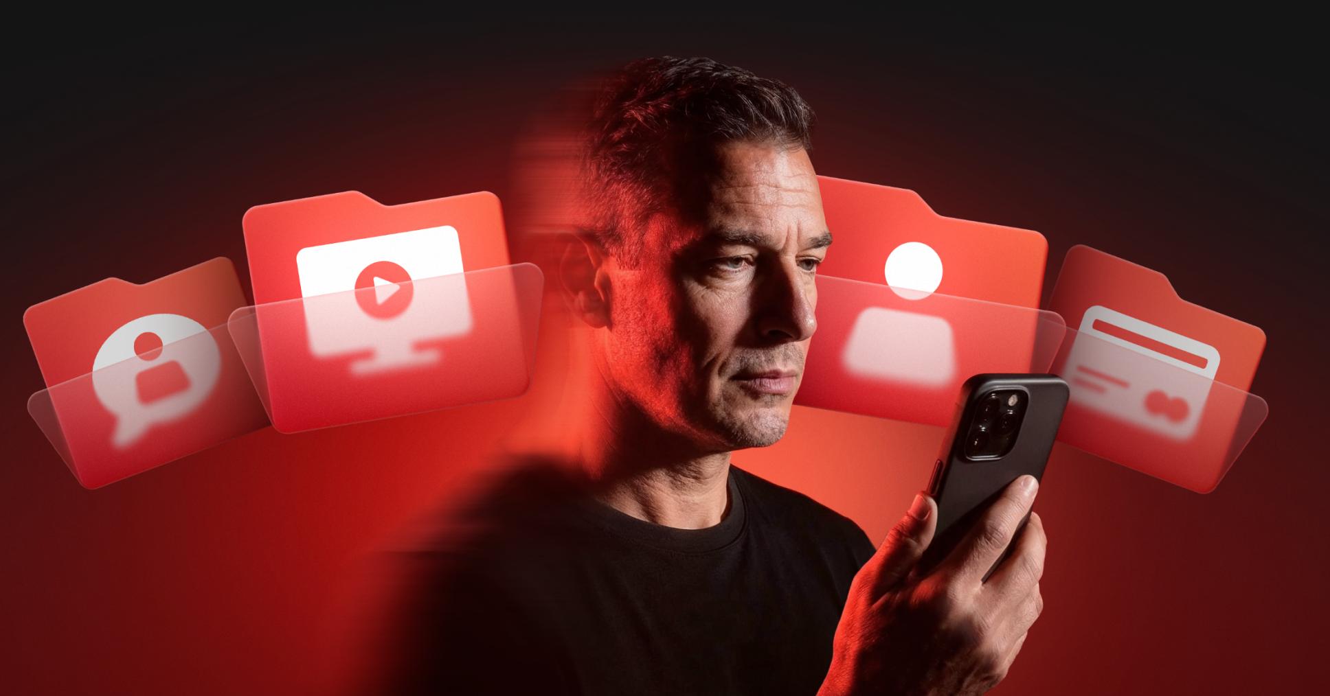 A man holding a smartphone surrounded by glowing red icons representing personal files and accounts.