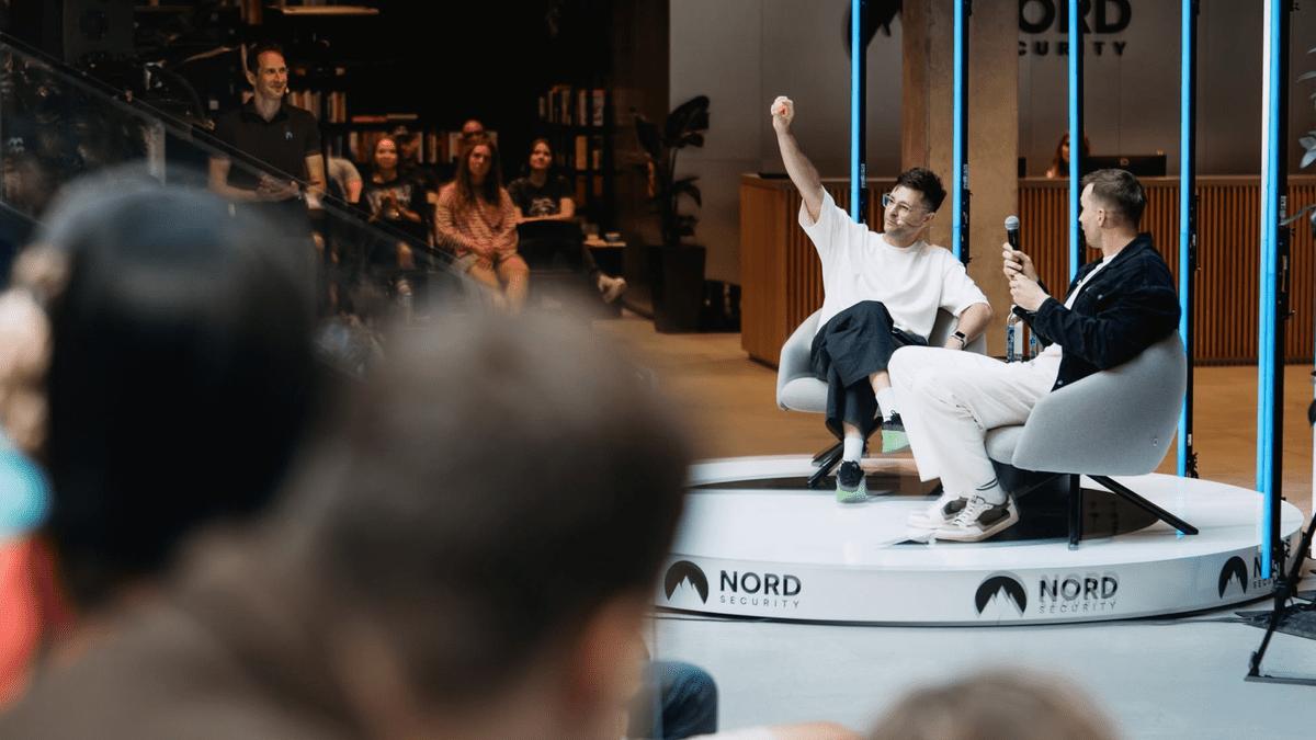 Two speakers in a fireside chat on a Nord Security stage.