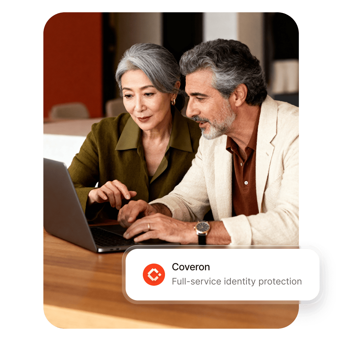 Couple using Coveron identity theft protection service on a laptop