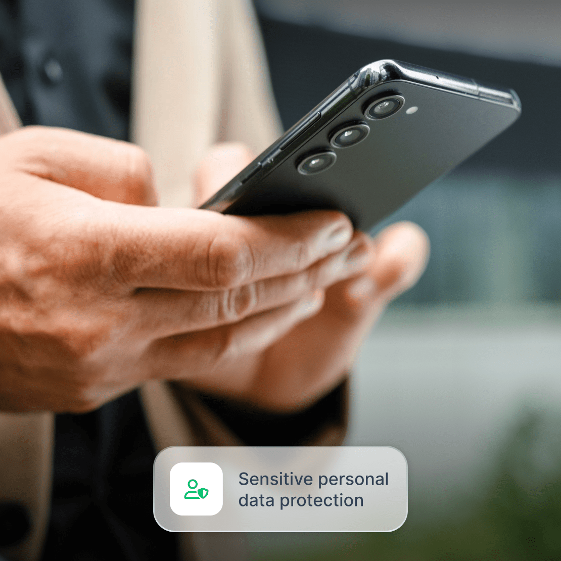 A person using a smartphone to protect sensitive data from malicious actors.