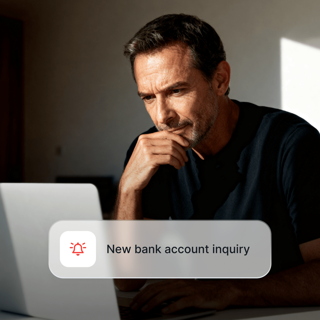 A person receiving a Coveron alert about a new bank account inquiry.