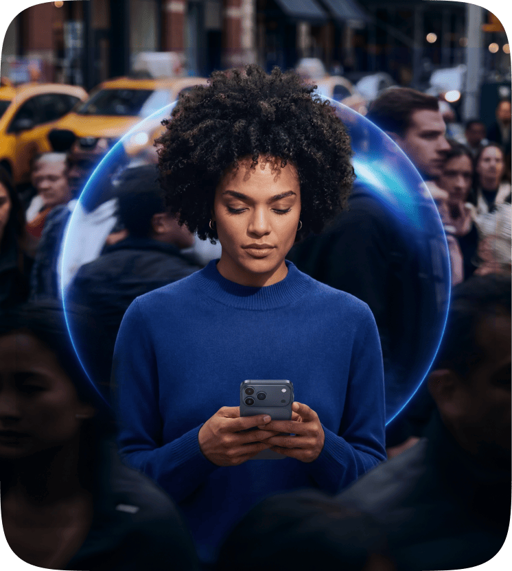A person using a phone on a busy city street, surrounded by a glowing blue ring of protection.