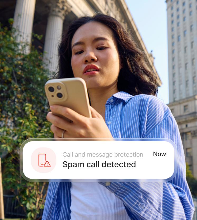 A woman receives a warning that an incoming call may be a scam.