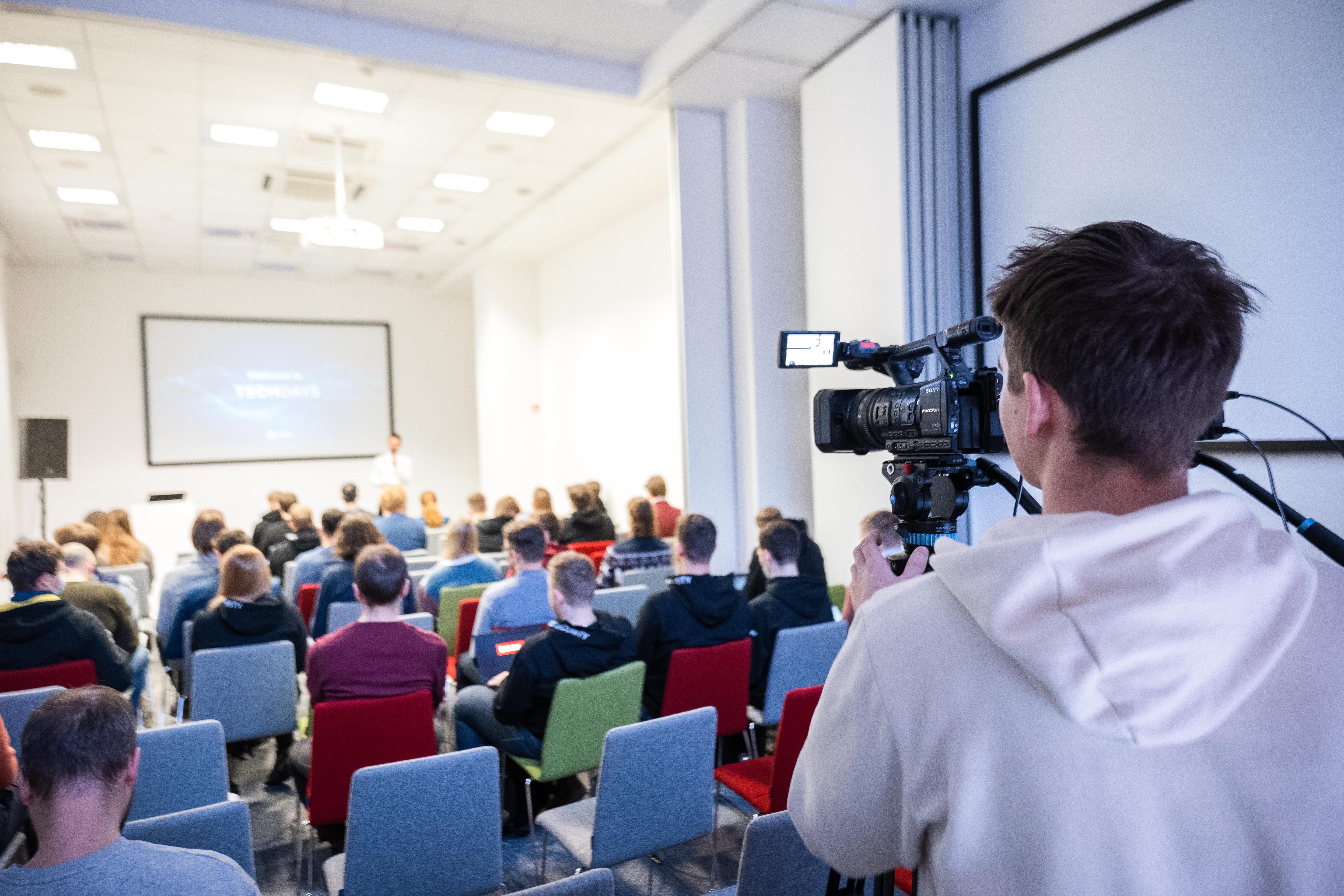 Camera operator filming a talk at Nord Security Tech Days.