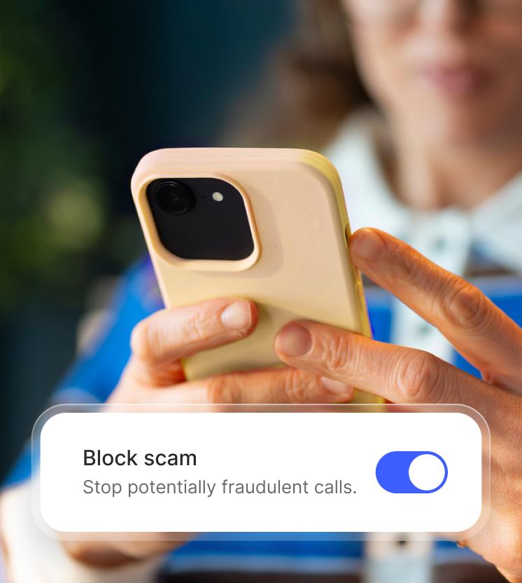 A woman enables the spam call blocker on her phone.