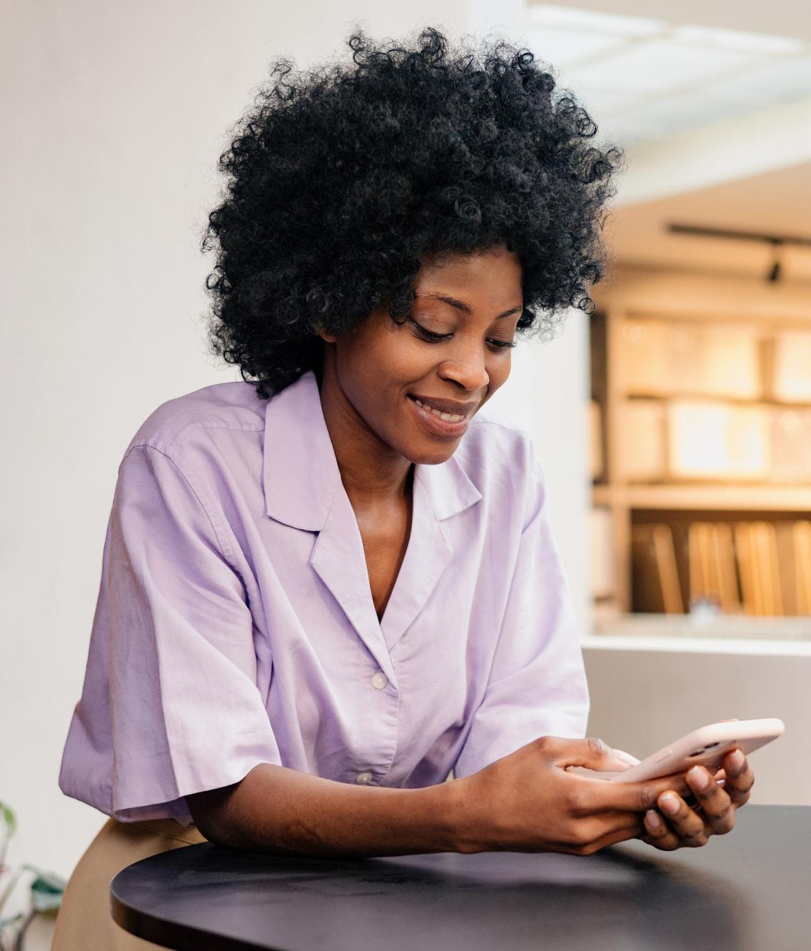 Woman using NordLocker cloud storage on her phone.