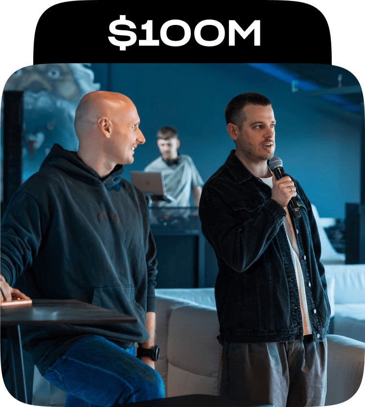 Nord Security co-founders Tomas Okmanas and Eimantas Sabaliauskas speaking to the team in the office, under a $100M caption.
