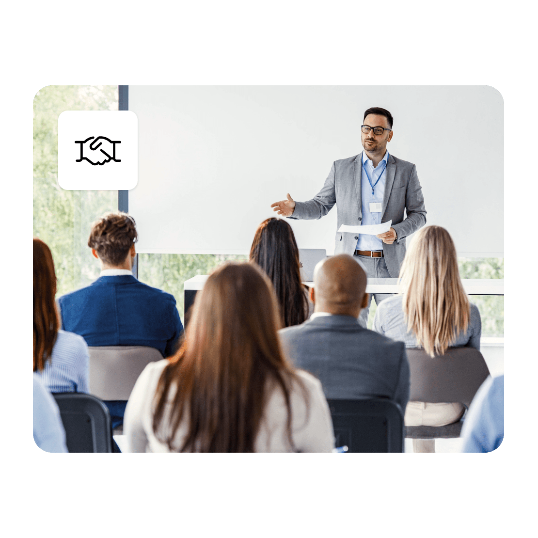 A group of people watch a cybersecurity business conference speaker