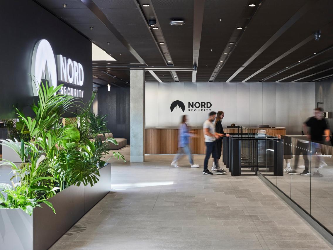 Nord Security office lobby, with the Nord Security logo on the wall behind the reception desk.