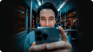 A person staring into their smartphone screen while on the bus.