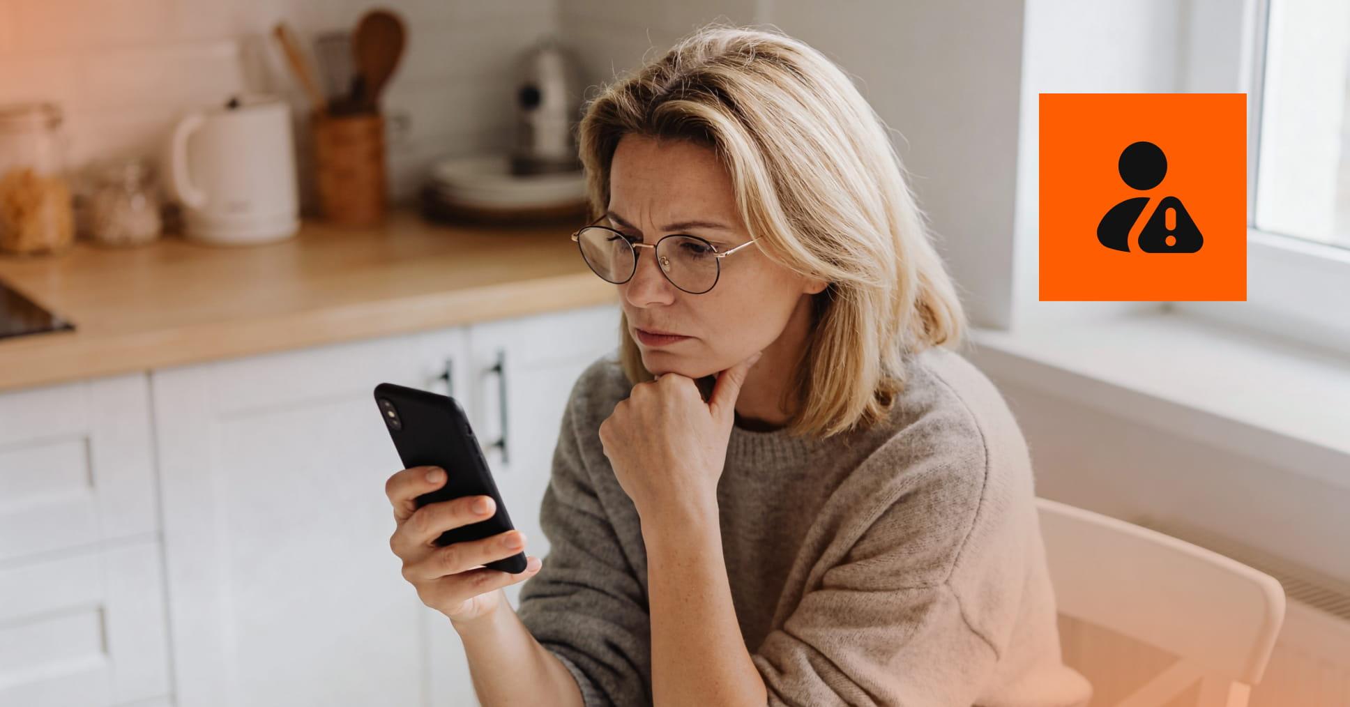 A person checking their phone to see whether their personal data has been compromised.