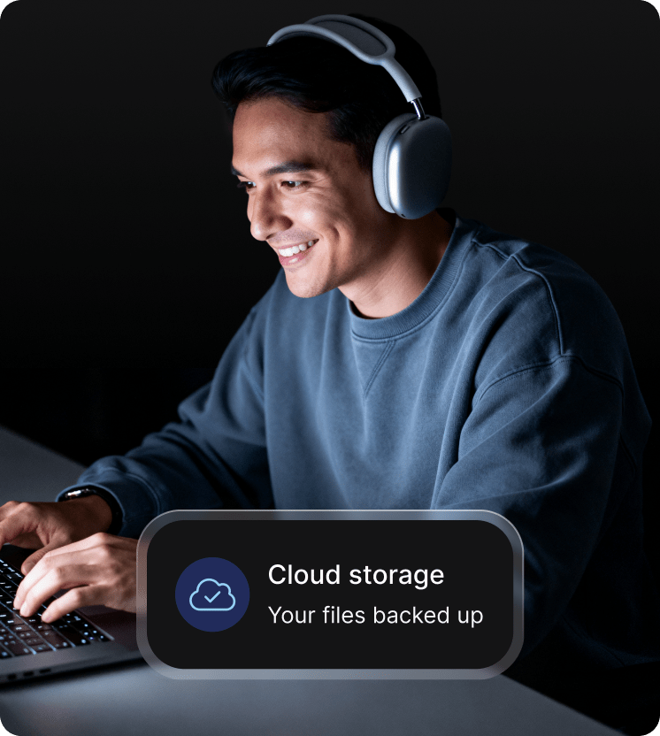 A man using his laptop to access cloud storage.