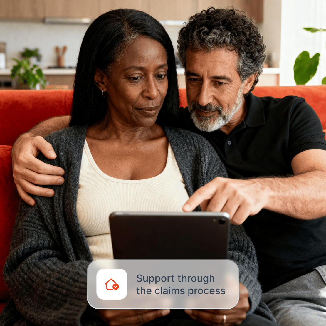 A woman and a man use a tablet while getting support with a home title insurance claim.