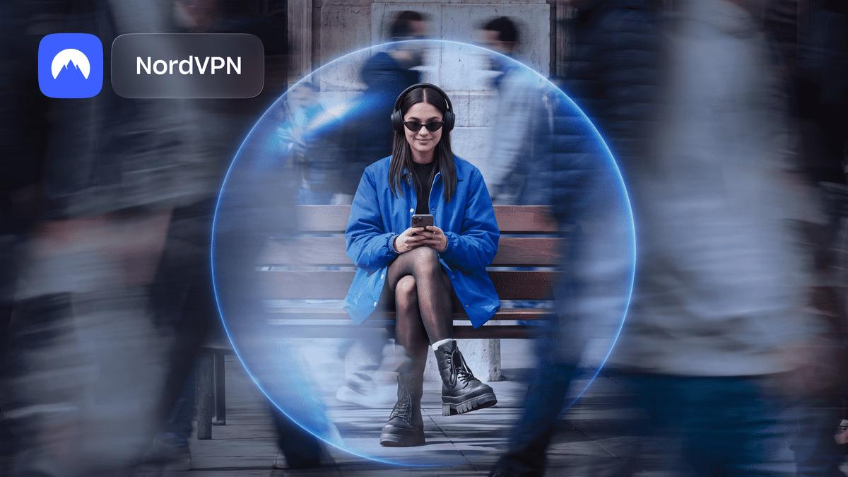 Woman in headphones sits on a bench inside a glowing blue NordVPN security bubble while blurred crowds rush past.