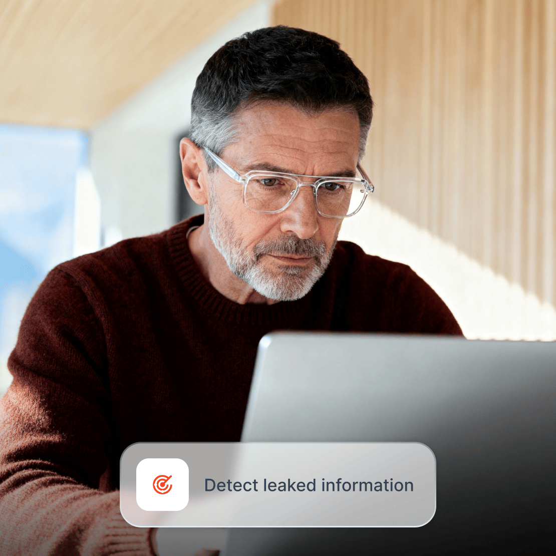 A man checks his laptop for personal information leaked on the dark web.