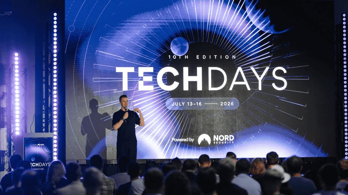 Marijus Briedis, CTO at NordVPN, on stage at Nord Security Tech Days in front of a large 'Tech Days' screen.