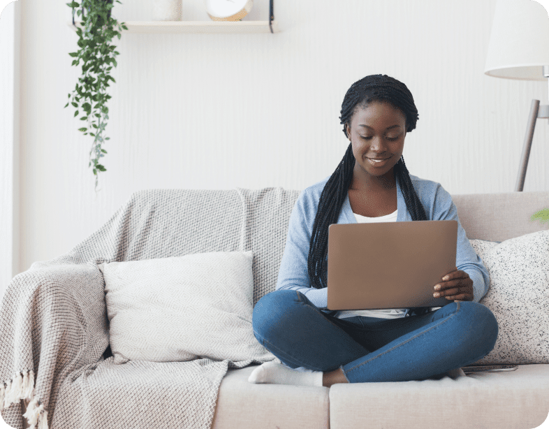 woman sitting couch laptop leaves