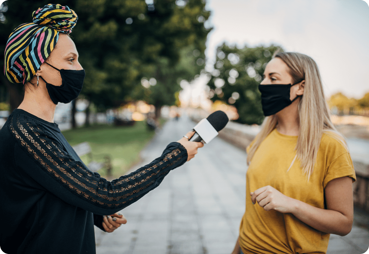 two women interview microphone